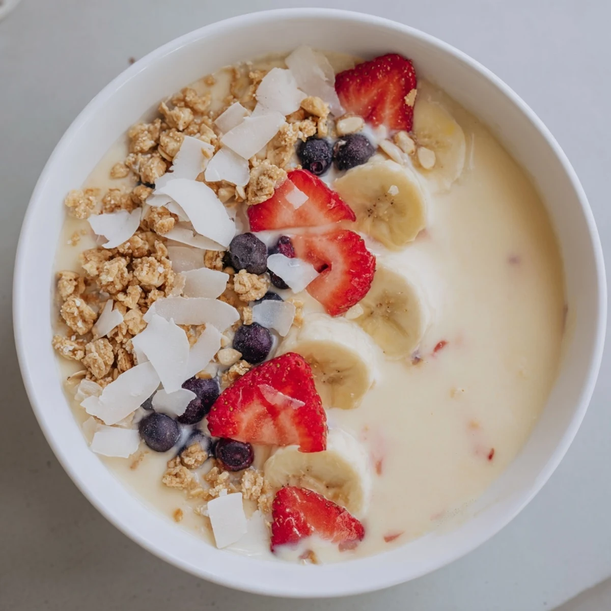 Frozen Breakfast Smoothie Packs in a bowl, topped with vibrant fruit ready to enjoy.