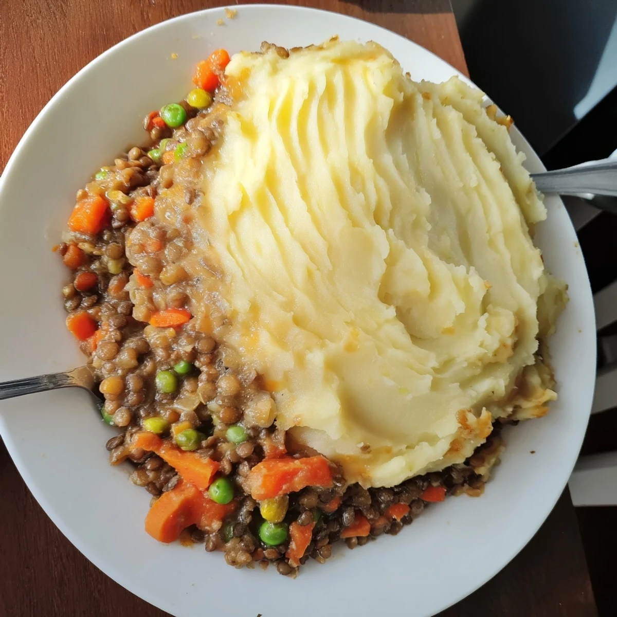 Enjoy the comforting sight of this baked Hearty Lentil Shepherd's Pie with perfectly browned potato crust.