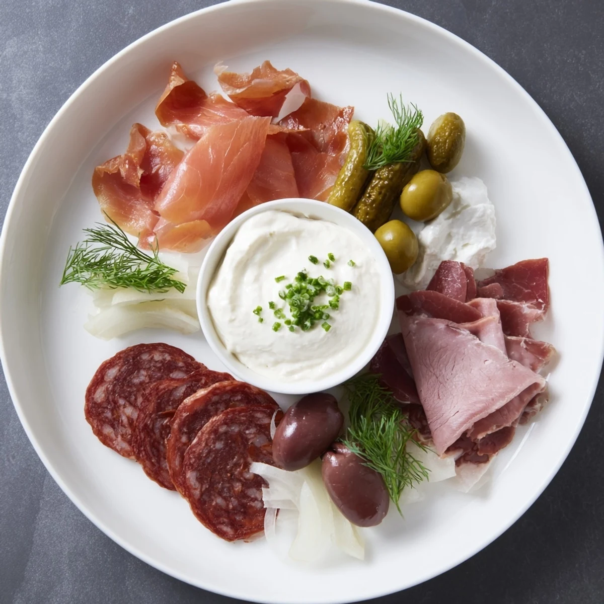 Guests enjoy The Compass Rose: savory cured meats radiating from a delicious, creamy dip in this arrangement.