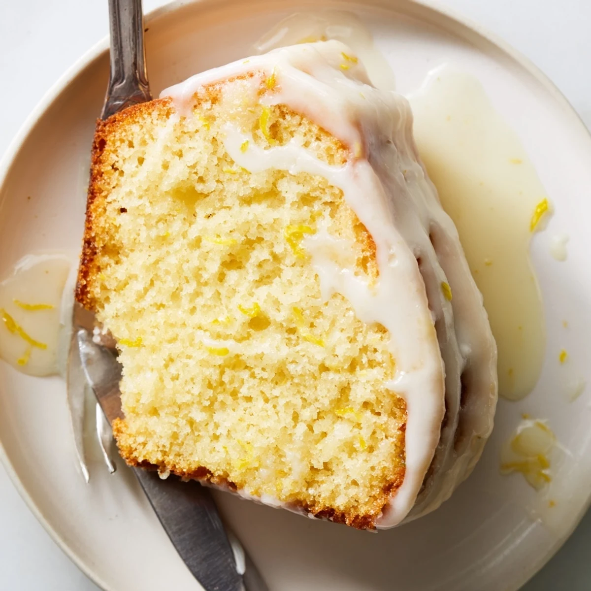 Warm, homemade lemon yogurt cake with a sweet glaze, offering a delightful combination of tastes.