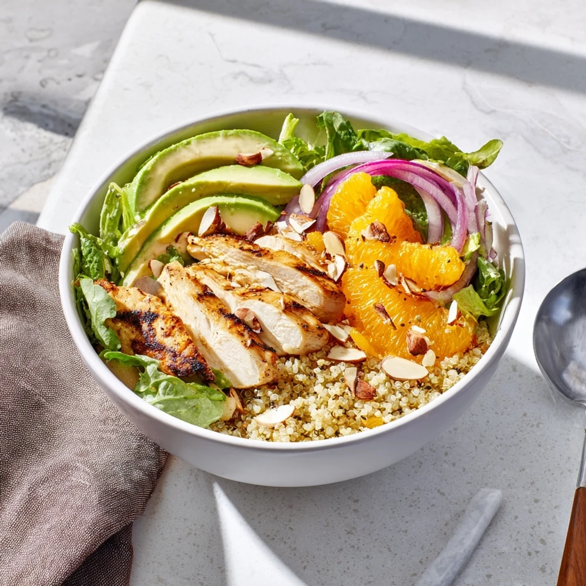Tender orange segments and creamy avocado add color to the wholesome Citrus Herb Chicken Salad Bowl, garnished with toasted almonds for a satisfying crunch.