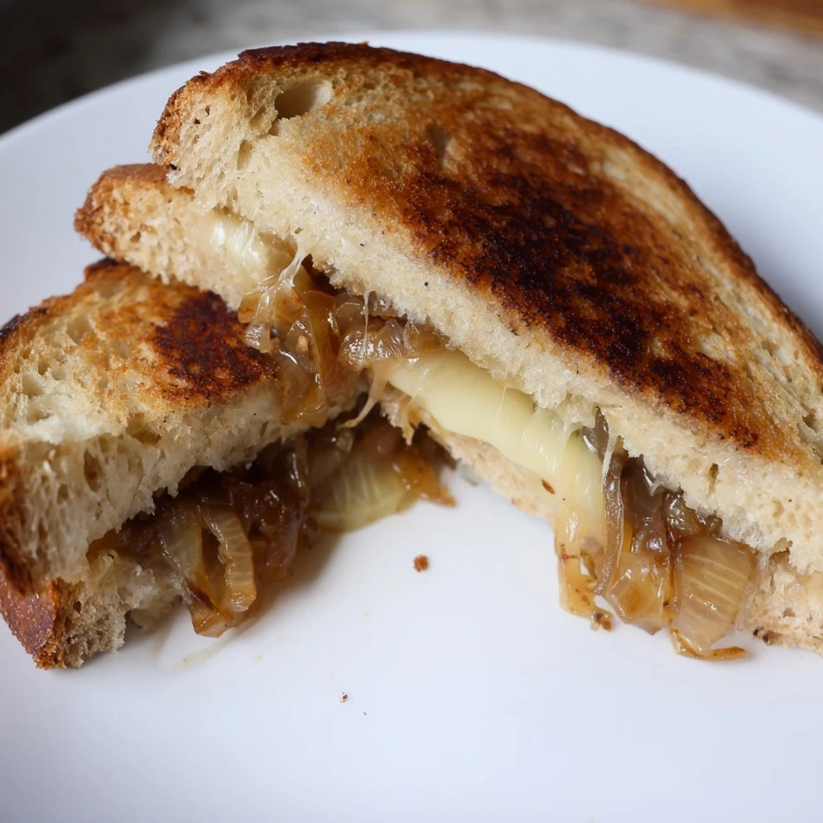 Gooey, nutty Gruyère and sweet caramelized onions melt between golden, buttery slices of country bread in this gourmet grilled cheese.