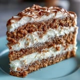 Freshly baked Fluffy Hojicha Cake shows a tender genoise sponge layered with creamy hojicha frosting and dusted with tea powder.