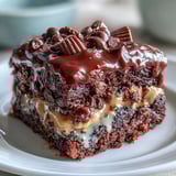 Slice of Rich Peanut Butter Cup Dump Cake served warm with vanilla ice cream and a drizzle of chocolate sauce.