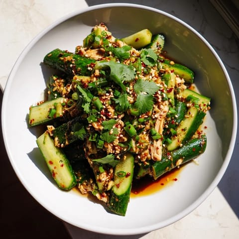 Fresh, smashed cucumbers shine in this attractive Whole Cucumber Logan Salad, ready to eat.