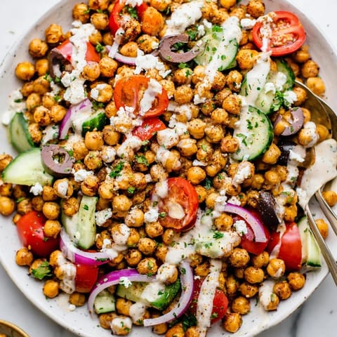 A delicious Mediterranean Chickpea Bowl featuring golden-brown roasted chickpeas and creamy tahini dressing.
