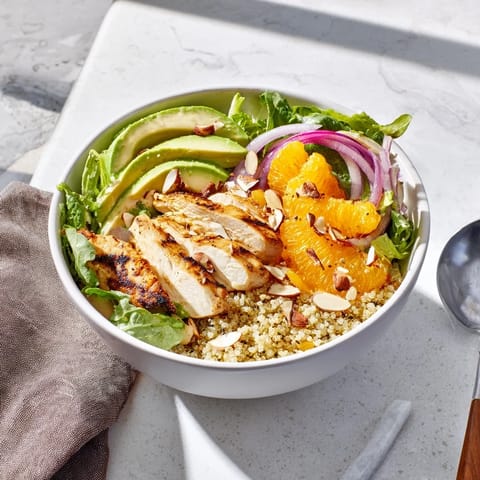 Tender orange segments and creamy avocado add color to the wholesome Citrus Herb Chicken Salad Bowl, garnished with toasted almonds for a satisfying crunch.