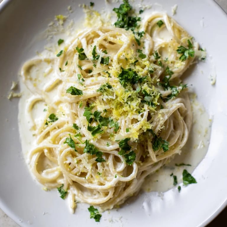 Fluffy pasta coated in luscious Lemon-Garlic Greek Yogurt Pasta sauce, plated and ready to enjoy now.