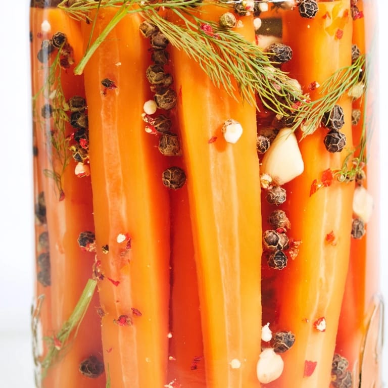 Colorful close-up of crunchy Quick Pickled Carrot Spears, a zesty American snack with garlic.