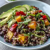 Vibrant Mango and Black Bean Brown Rice Fiesta Bowls with fresh mango, black beans, and zesty lime dressing.  